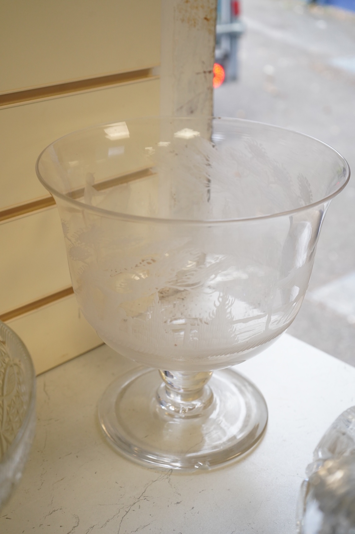 Two footed glass bowls engraved with racing and hunting scenes, an early 19th century oval cut glass fruit bowl, another, modern, together with a small Regency mallet shaped decanter, with an enamel label ‘’Whisky’’, (6)